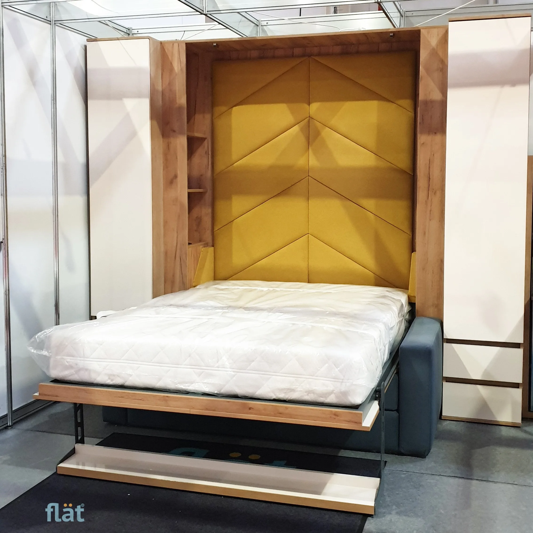 The 140 × 200 bed lowered over the sofa, with a soft yellow headboard